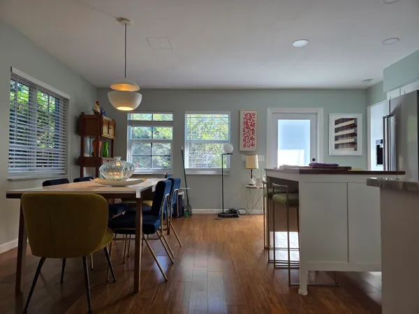 a view of a dining room with furniture window and wooden floor