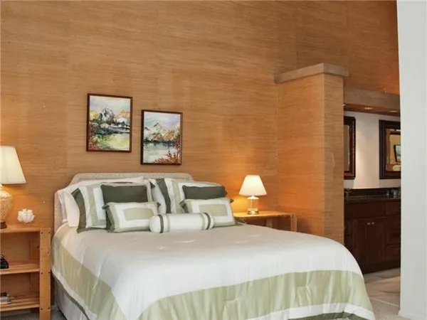 a bedroom with a bed and wall painting