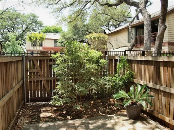 a view of a house with wooden fence