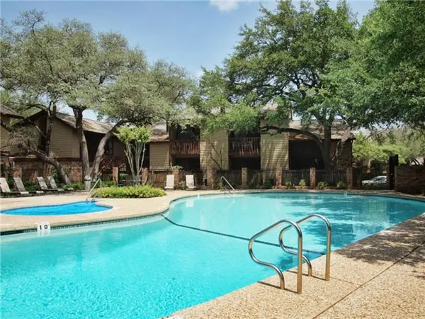 a view of a house with swimming pool and sitting area