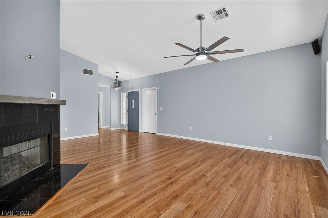 2609 Shakespeare Road Las Vegas, NV 89108 - Photo 9 of 41 Vast living space with rich hardwood floors and a cozy fireplace awaits your personal touch.