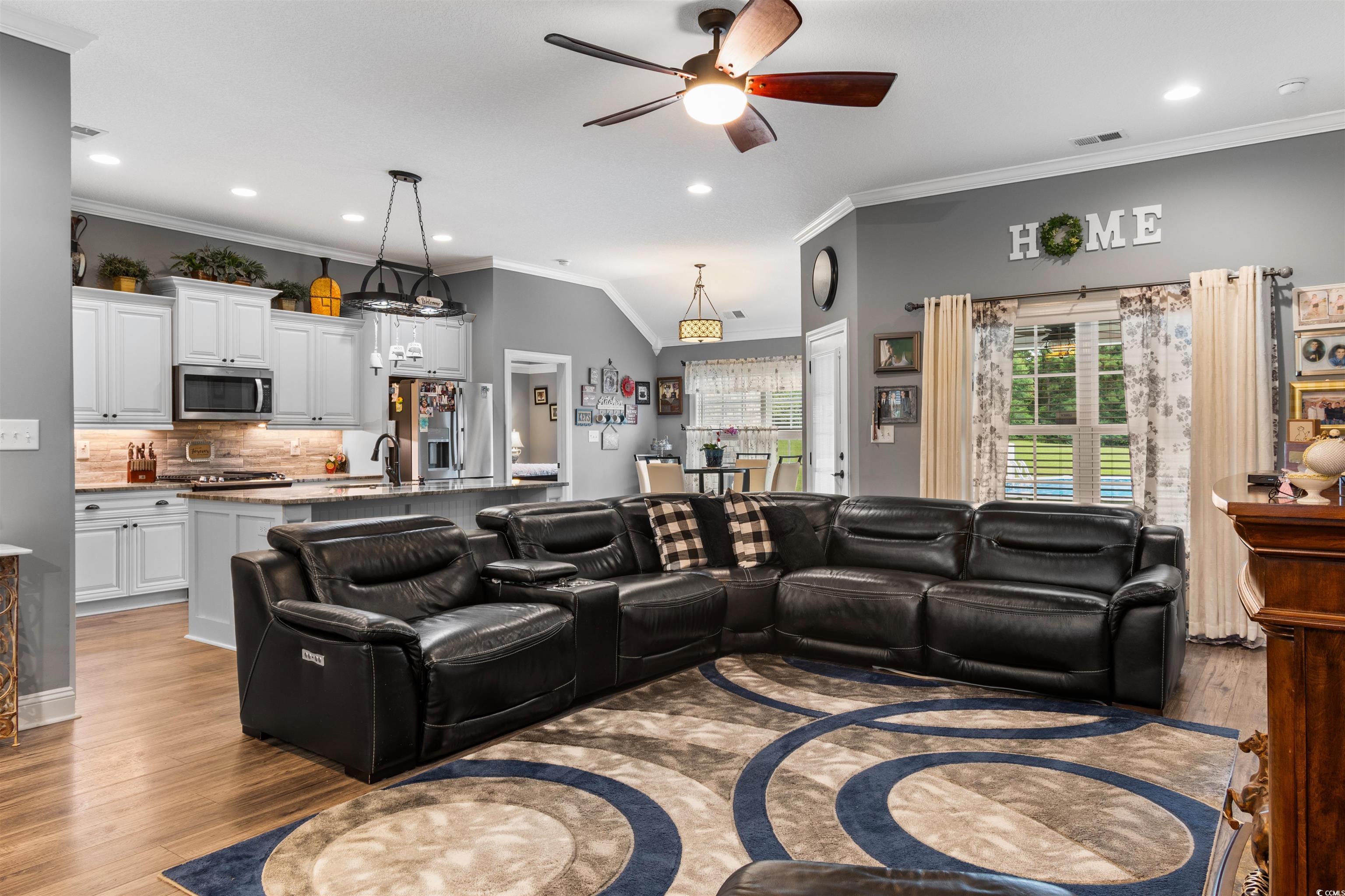 1896 Bud Graham Road Galivants Ferry, SC 29544 - Photo 11 of 36 Living room with vaulted ceiling, sink, light hard