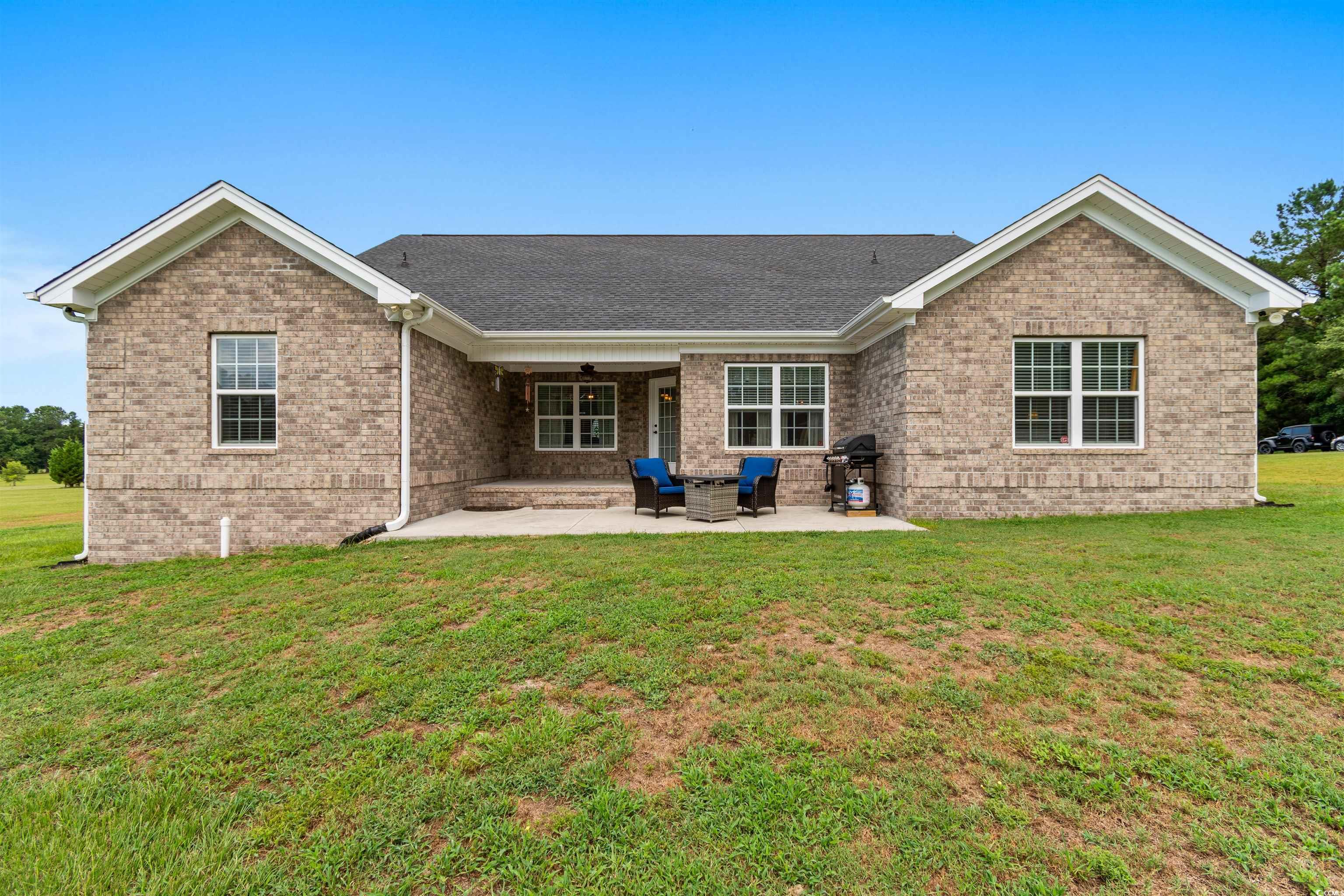1896 Bud Graham Road Galivants Ferry, SC 29544 - Photo 32 of 36 Back of house with a patio and a lawn