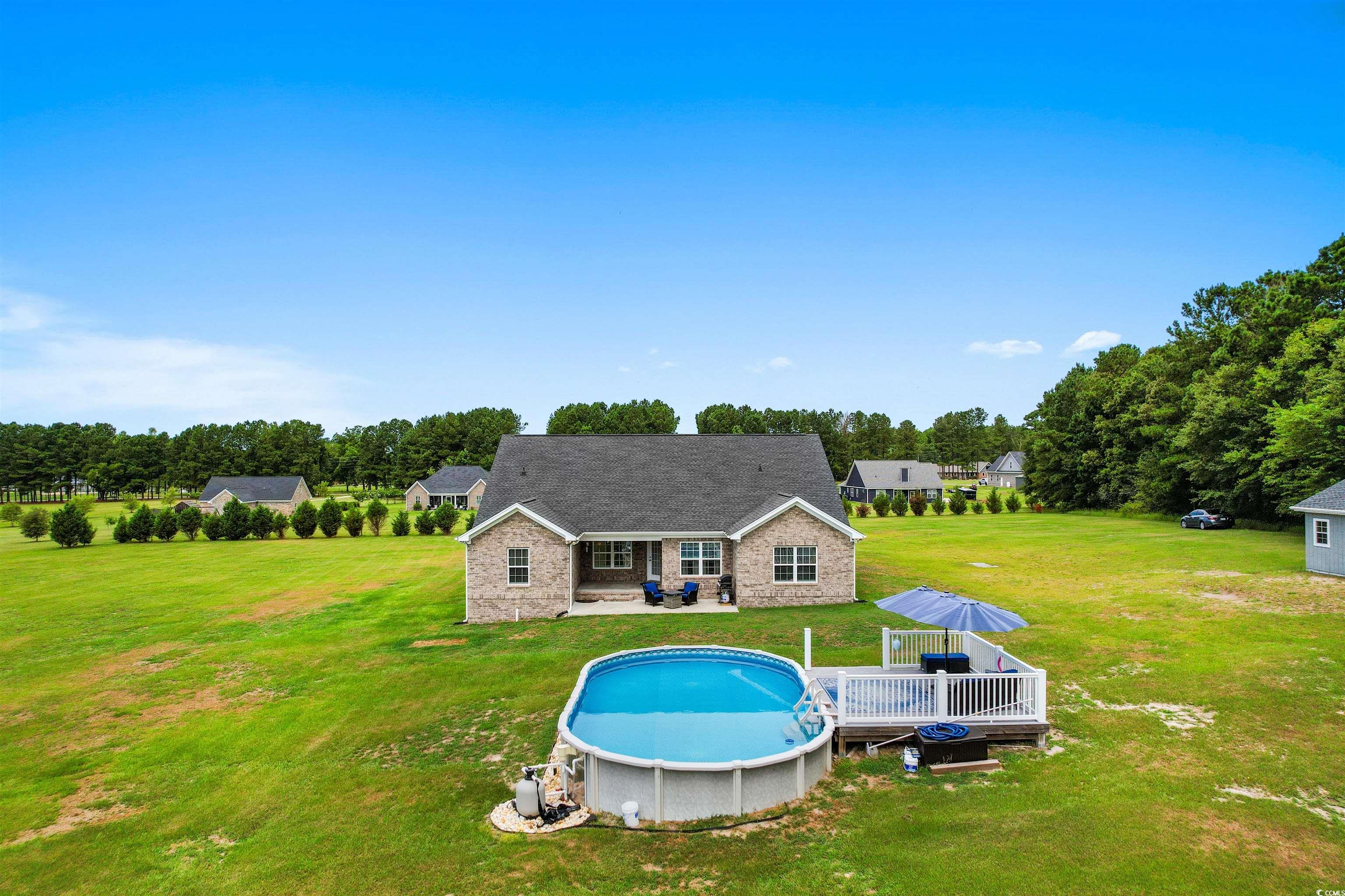 1896 Bud Graham Road Galivants Ferry, SC 29544 - Photo 33 of 36 View of swimming pool featuring a deck and a yard