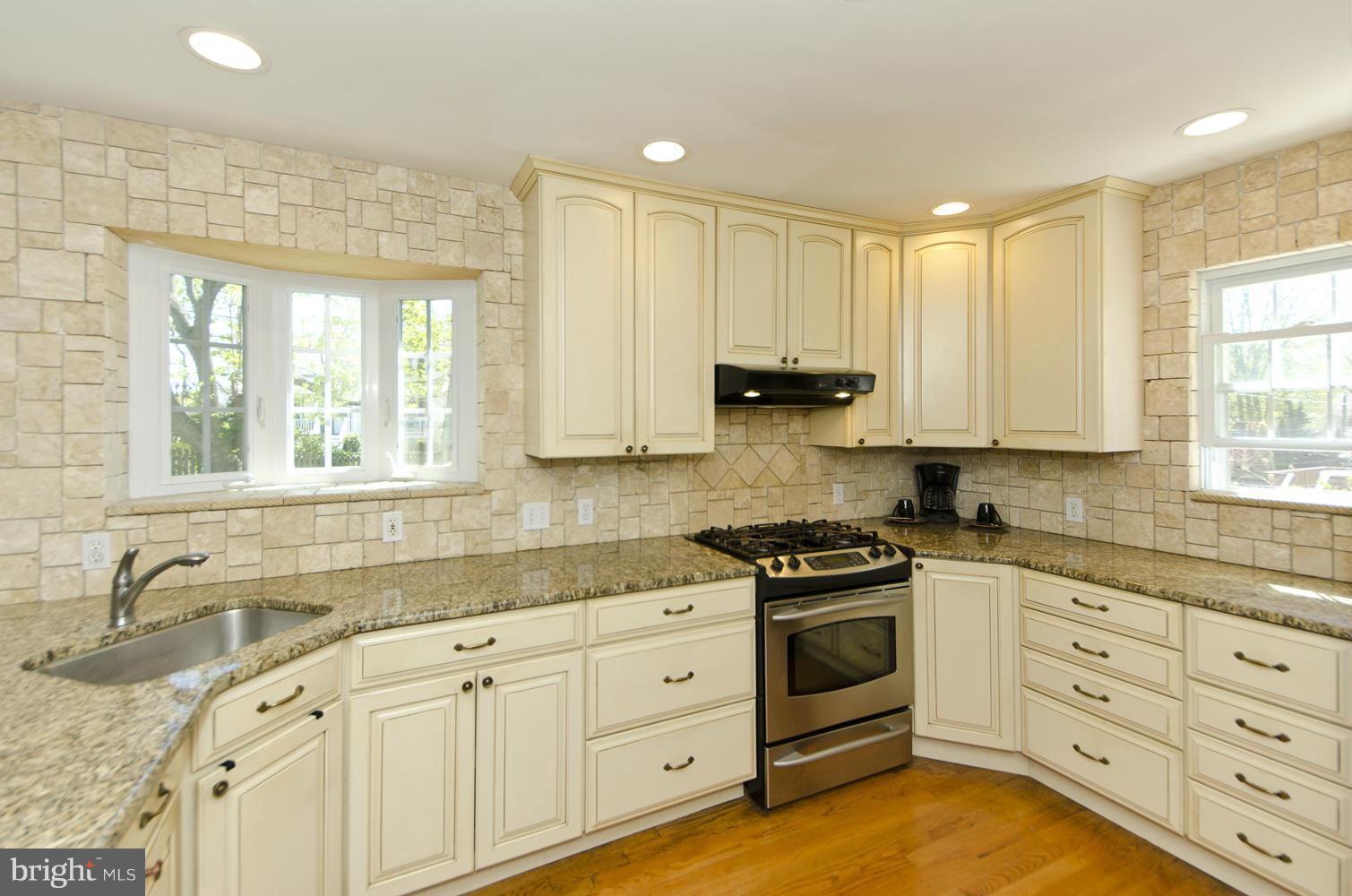 5700 25th Road North Arlington, VA 22207 - Photo 11 of 29 a kitchen with granite countertop white cabinets and white stainless steel appliances