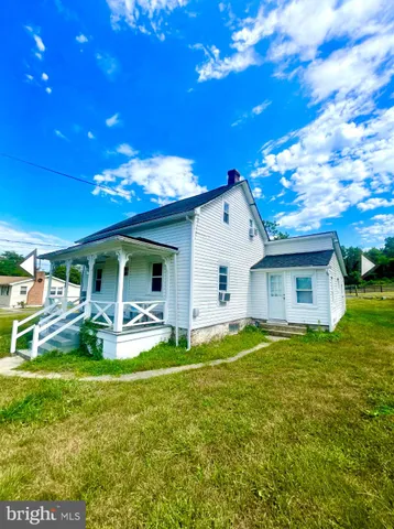 a view of a house with a yard patio and fire pit