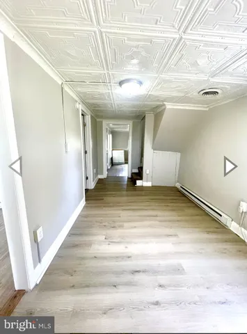 a view of a room with wooden floor