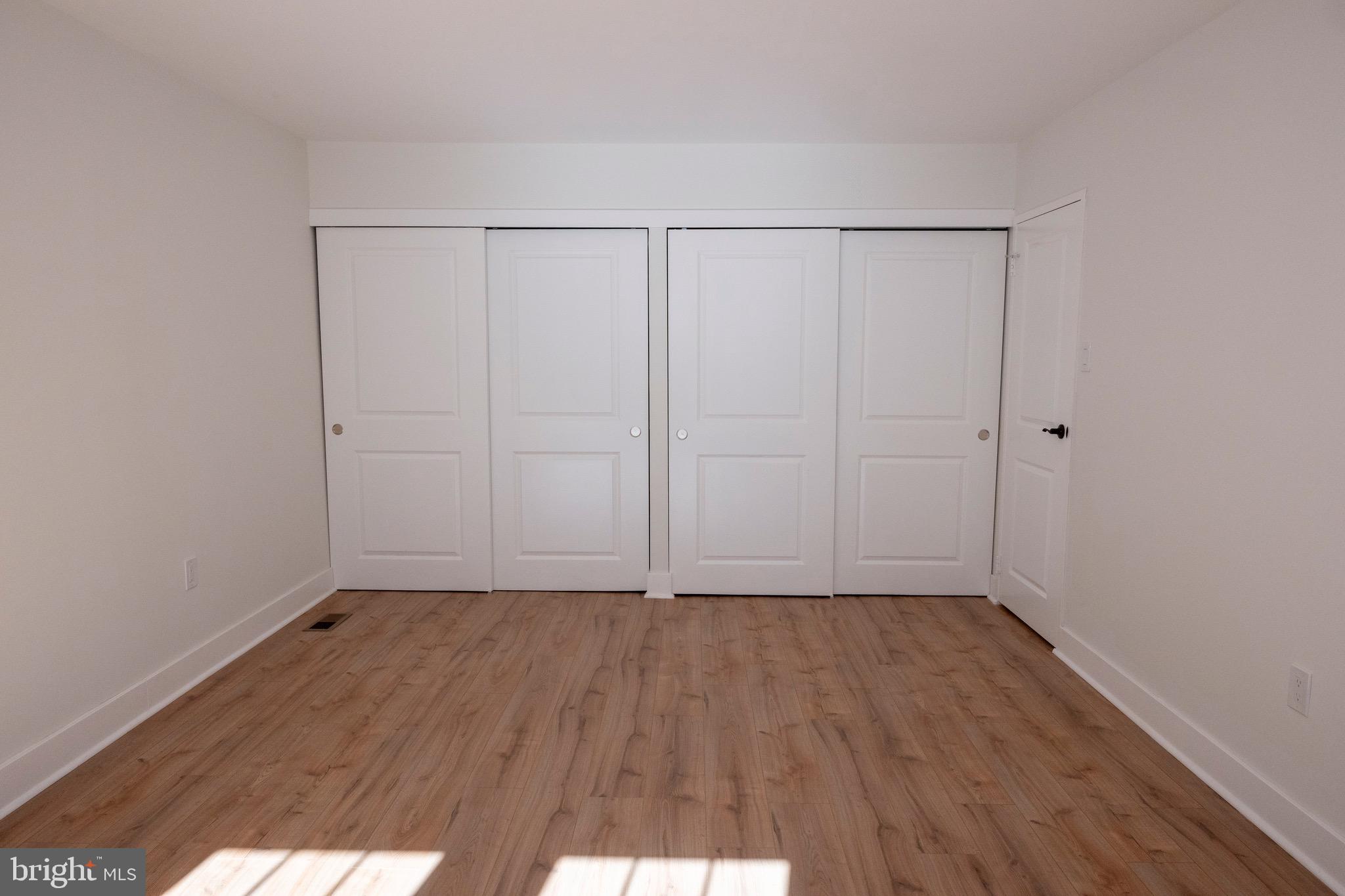 2201 Strahle Street, Unit D3 Philadelphia, PA 19152 - Photo 11 of 21 a view of an empty room with wooden floor