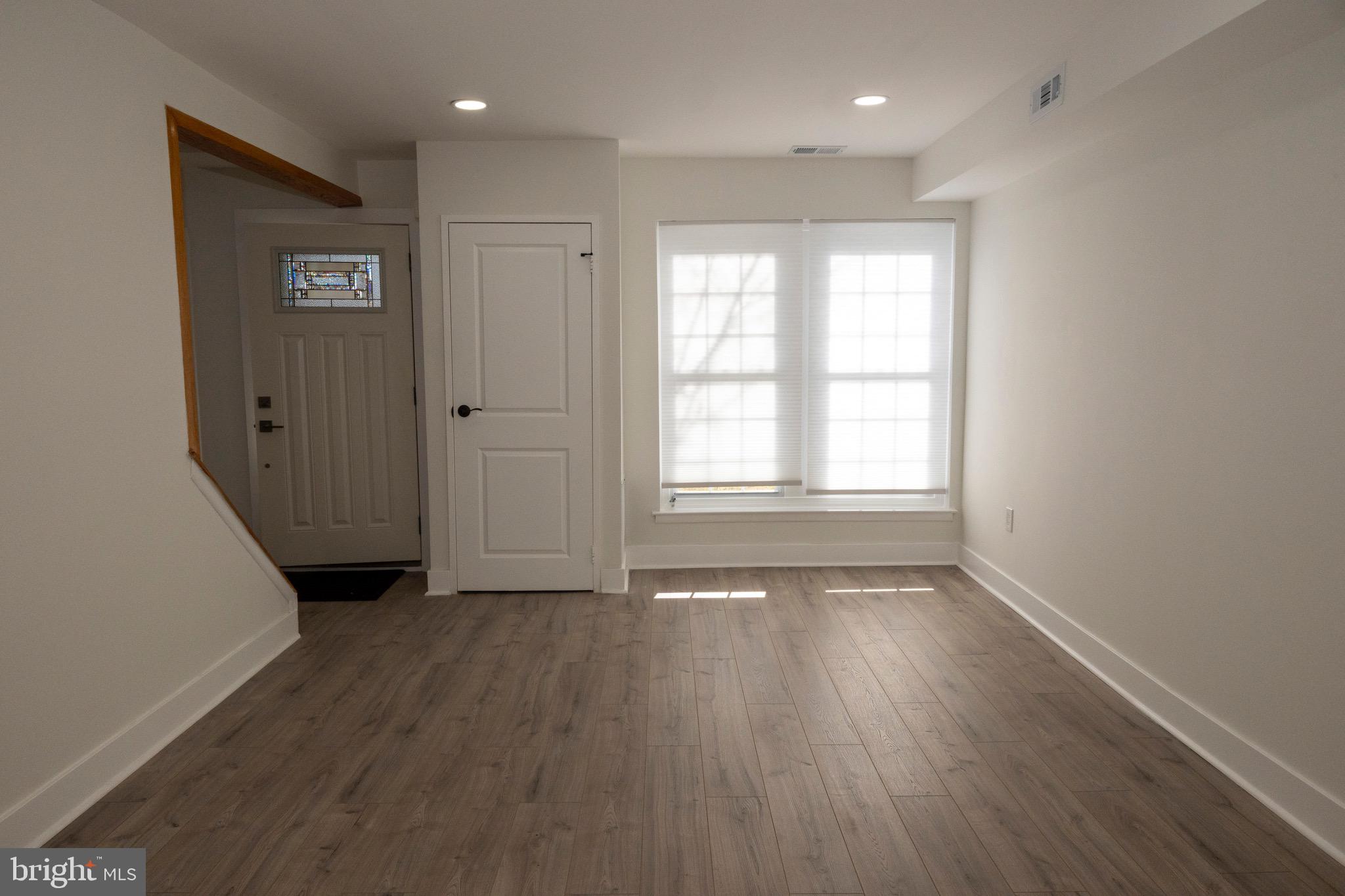 2201 Strahle Street, Unit D3 Philadelphia, PA 19152 - Photo 15 of 21 a view of an empty room with wooden floor and a window