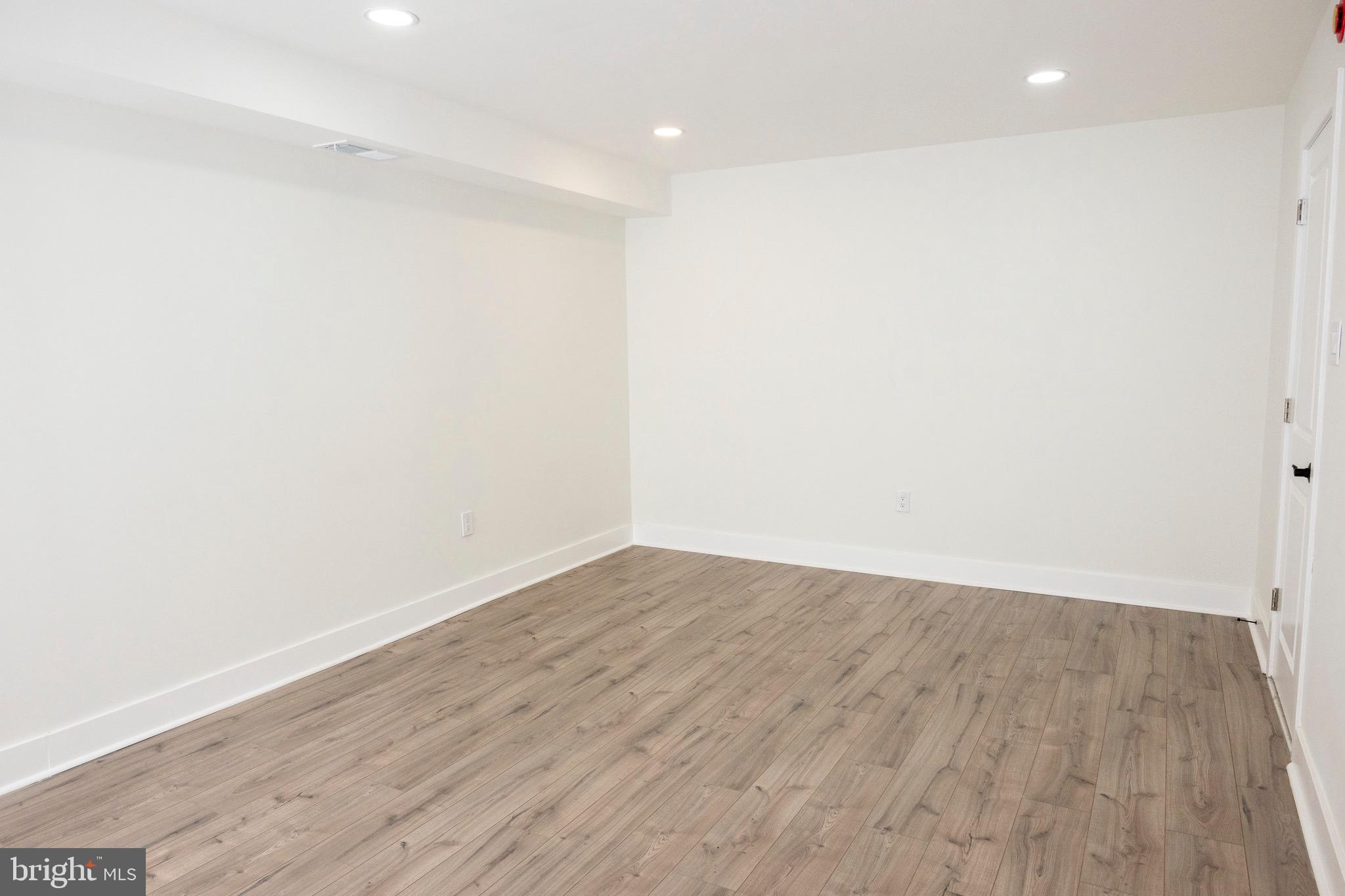 2201 Strahle Street, Unit D3 Philadelphia, PA 19152 - Photo 7 of 21 a view of an empty room with wooden floor and a window
