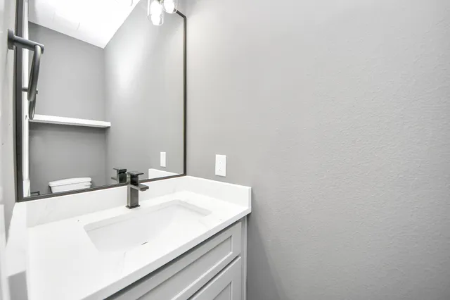 a bathroom with a sink and a mirror