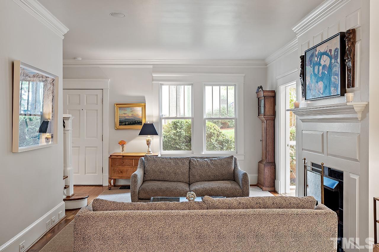 2001 McCarthy Street Raleigh, NC 27608 - Photo 12 of 43 a living room with fireplace furniture and a large window