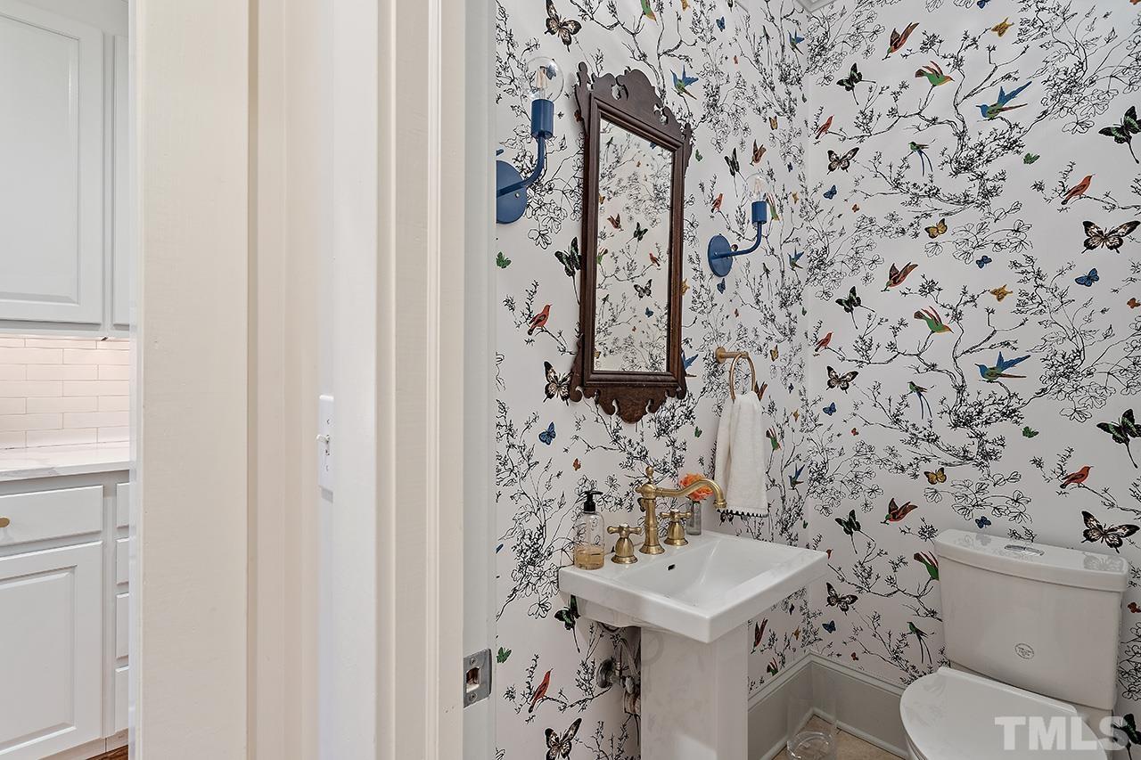 2001 McCarthy Street Raleigh, NC 27608 - Photo 25 of 43 a bathroom with a toilet and a shower curtain