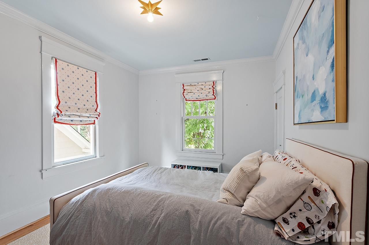 2001 McCarthy Street Raleigh, NC 27608 - Photo 28 of 43 a bedroom with a bed and a window
