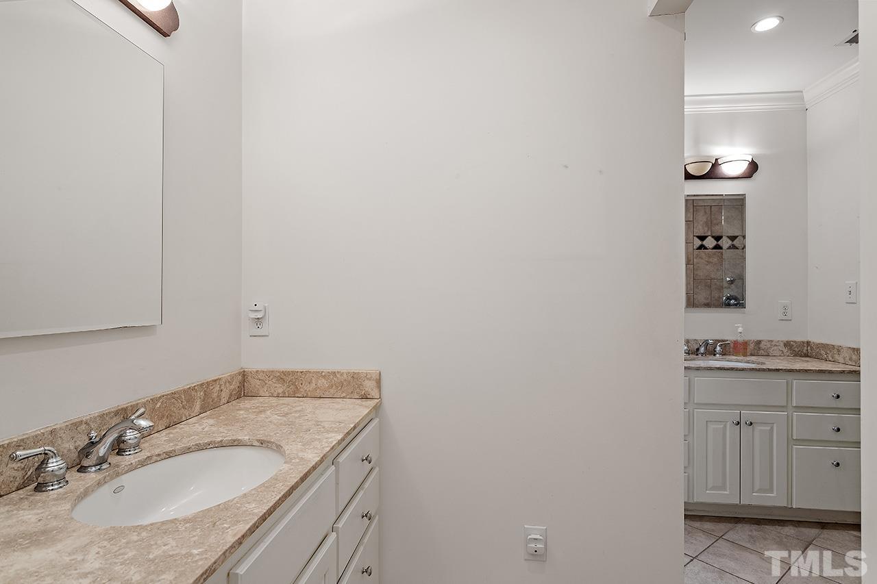 2001 McCarthy Street Raleigh, NC 27608 - Photo 36 of 43 a bathroom with a granite countertop sink and a mirror