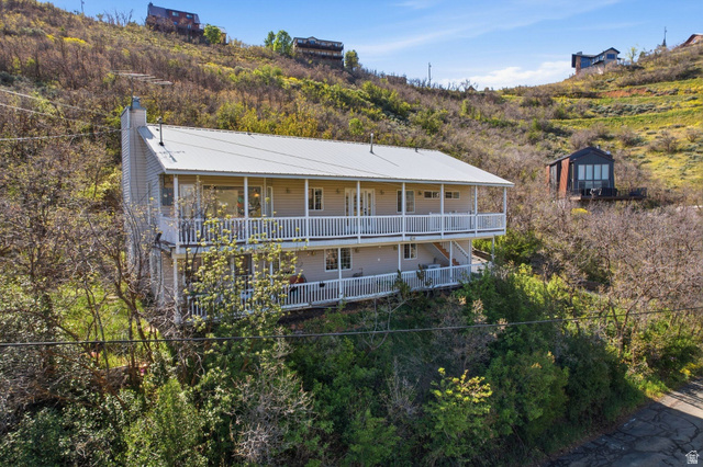380 Luzern Road Midway, UT 84049 - Photo 6 of 74 Two-story residence featuring a metal roof, light-colored siding, and dual-level covered balconies with white railings