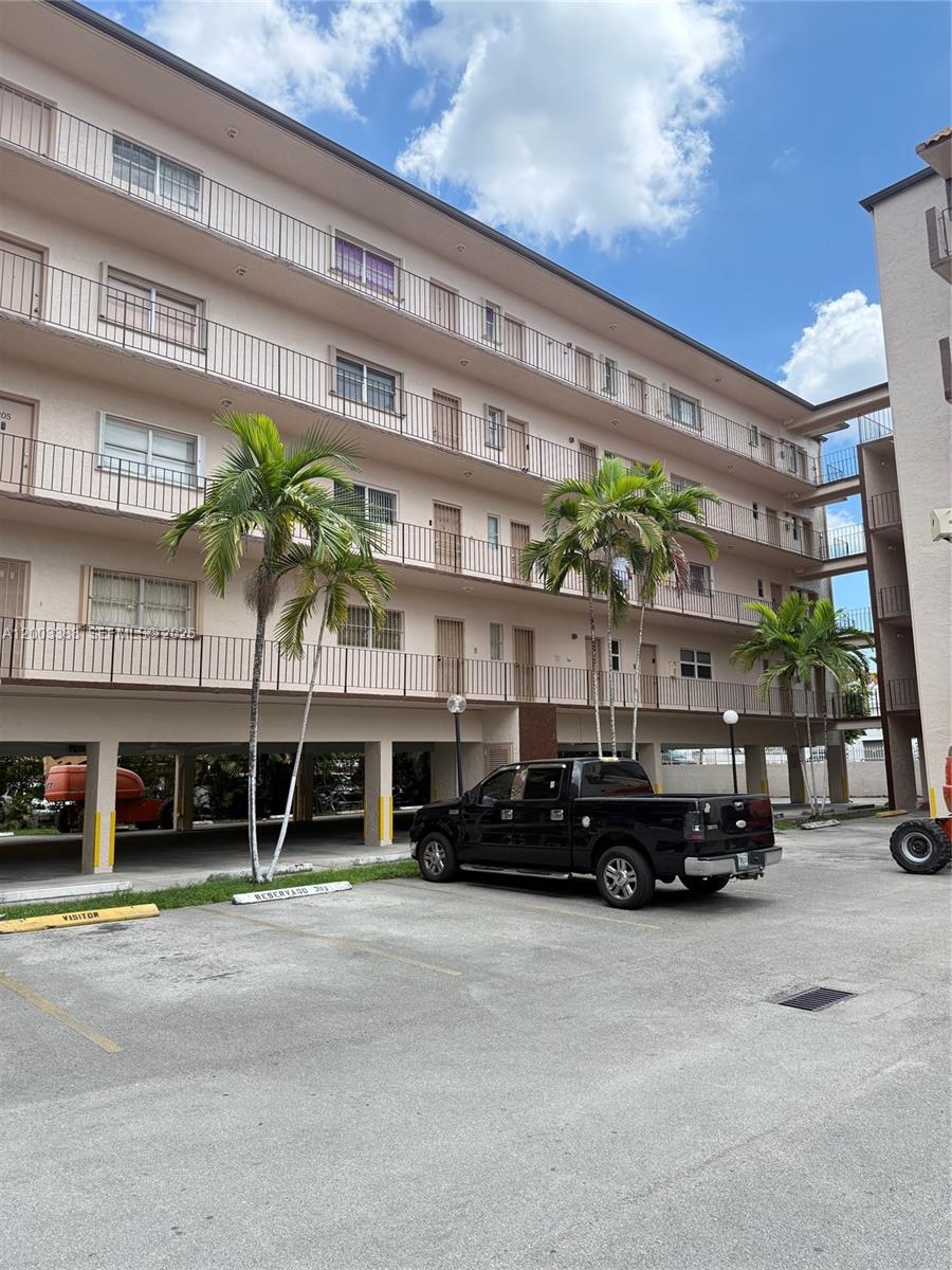 1950 West 54th Street, Unit 115 Hialeah, FL 33012 - Photo 1 of 28 a car parked in front of a building