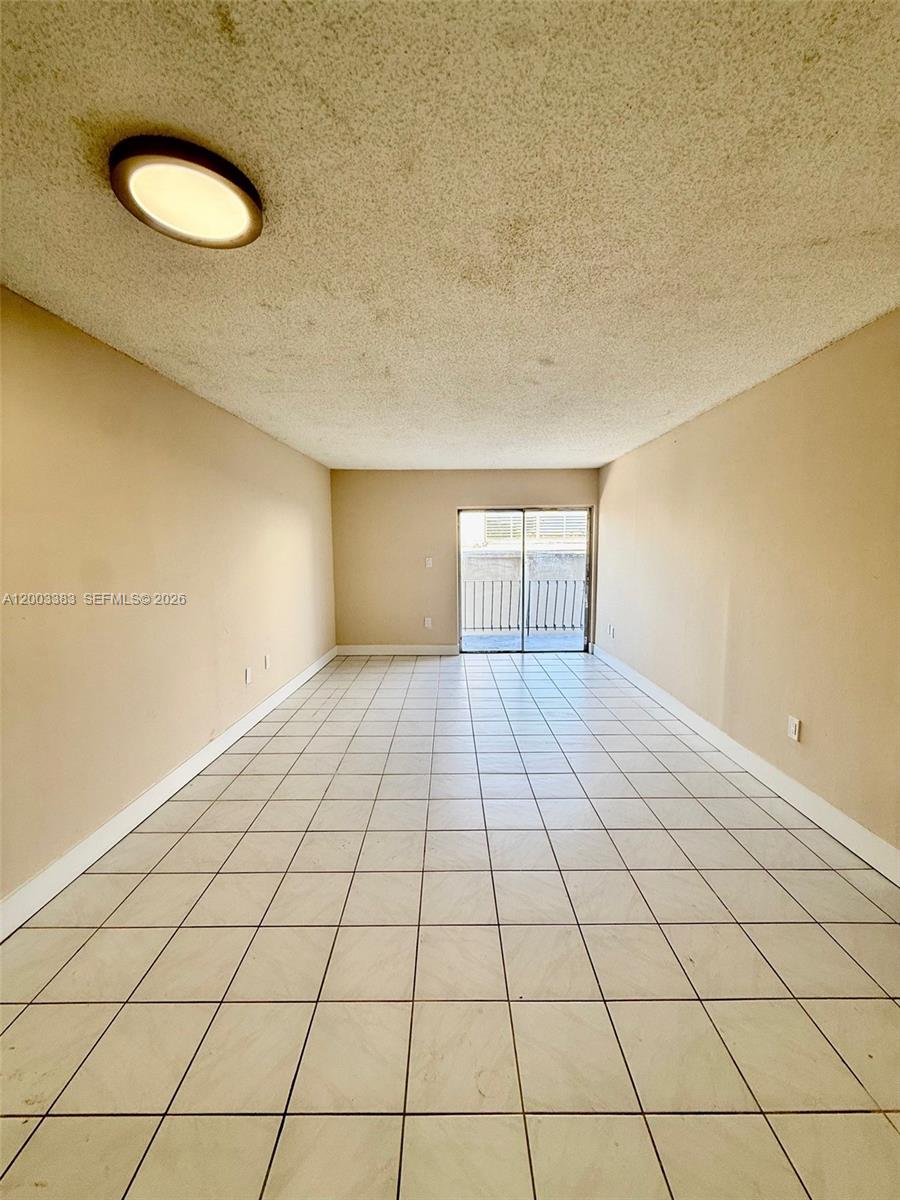 1950 West 54th Street, Unit 115 Hialeah, FL 33012 - Photo 11 of 28 a view of a room has white walls and tiles
