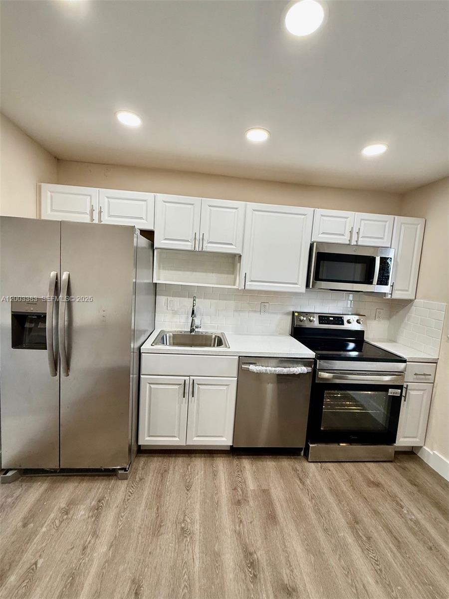 1950 West 54th Street, Unit 115 Hialeah, FL 33012 - Photo 13 of 28 a kitchen with stainless steel appliances granite countertop a refrigerator a stove and a sink