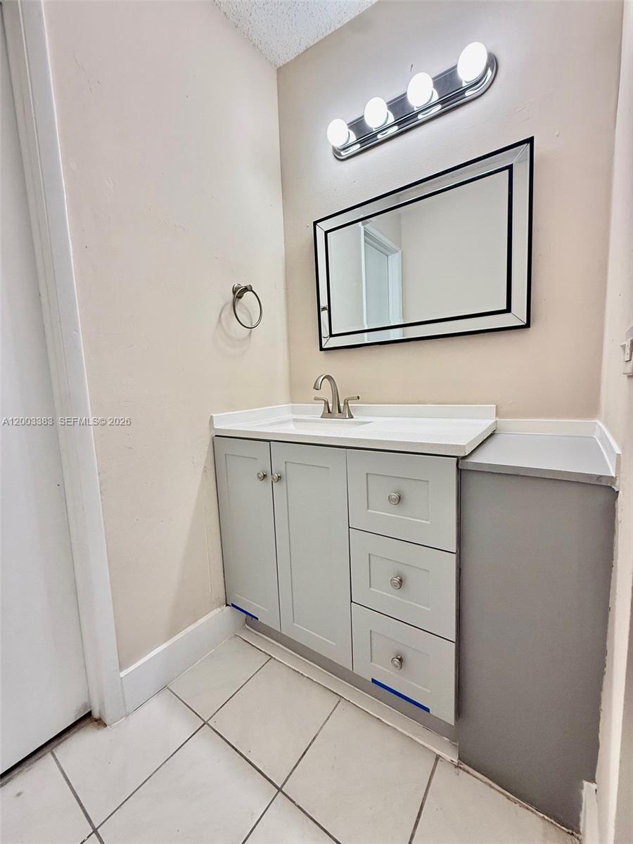 1950 West 54th Street, Unit 115 Hialeah, FL 33012 - Photo 18 of 28 a bathroom with a sink a light fixture and a mirror