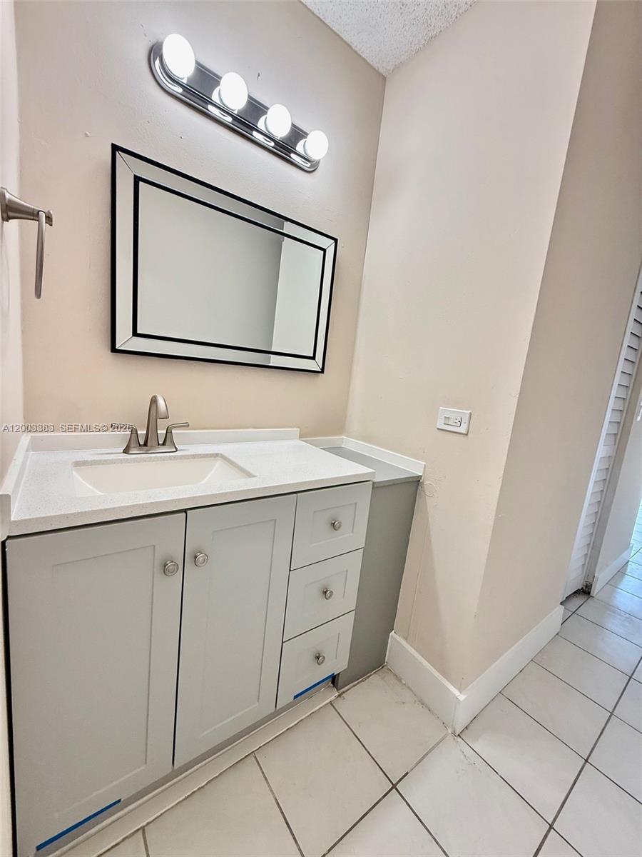 1950 West 54th Street, Unit 115 Hialeah, FL 33012 - Photo 20 of 28 a bathroom with a double vanity sink and mirror