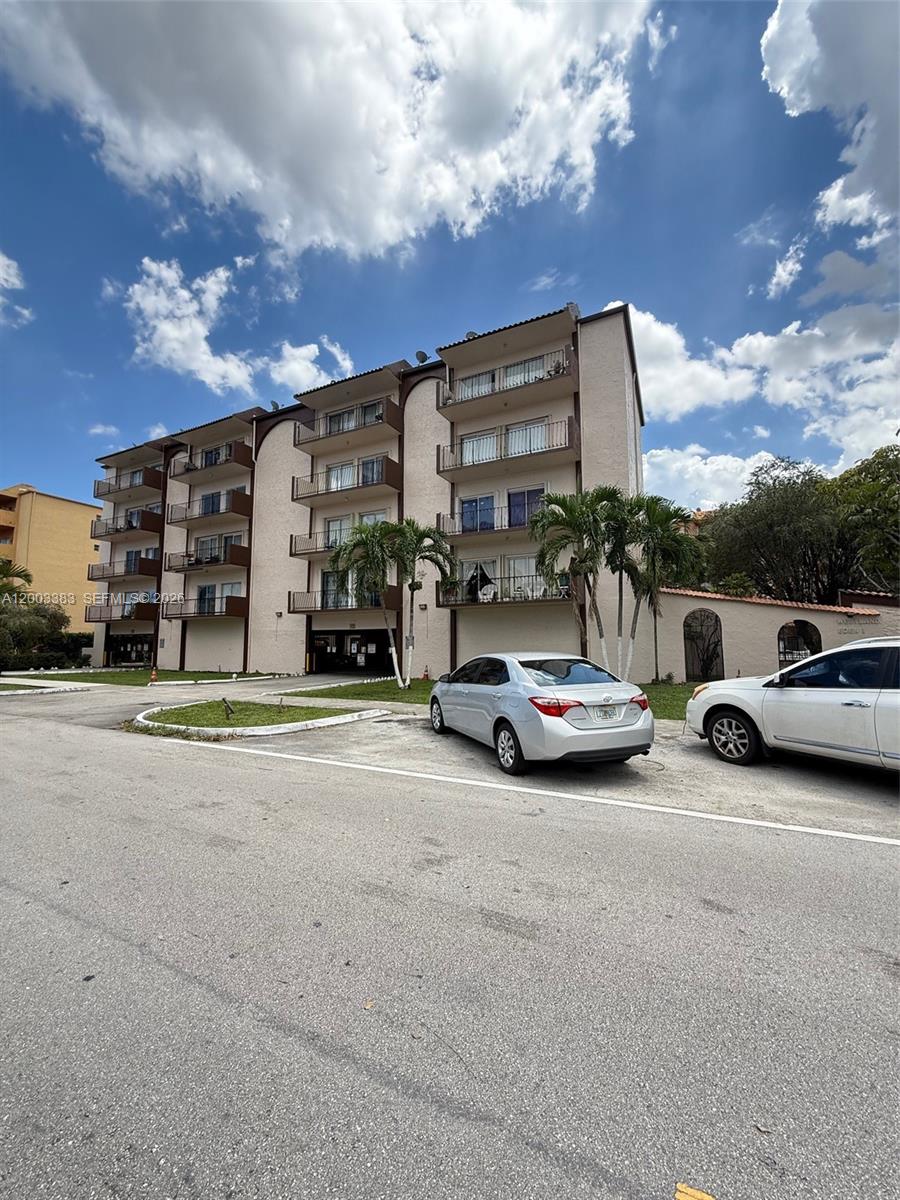 1950 West 54th Street, Unit 115 Hialeah, FL 33012 - Photo 2 of 28 a view of street with parked cars
