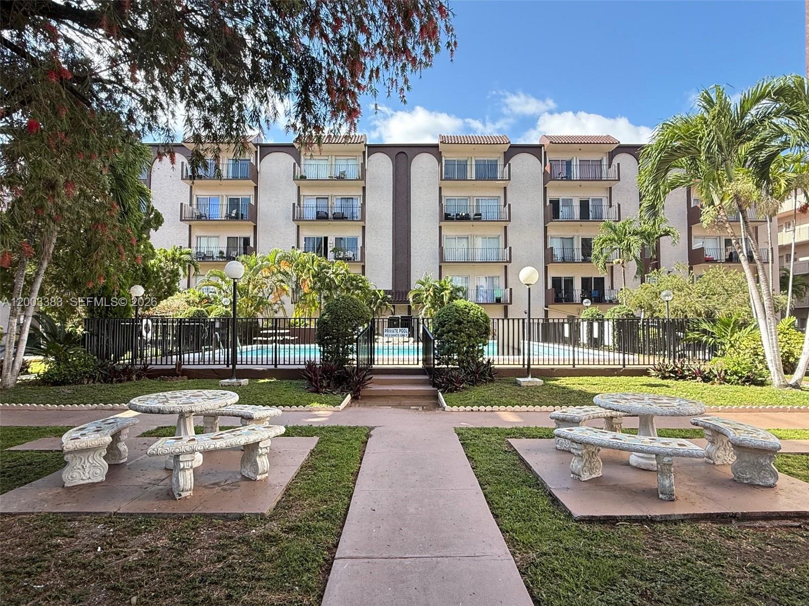 1950 West 54th Street, Unit 115 Hialeah, FL 33012 - Photo 4 of 28 a view of a building with garden and patio
