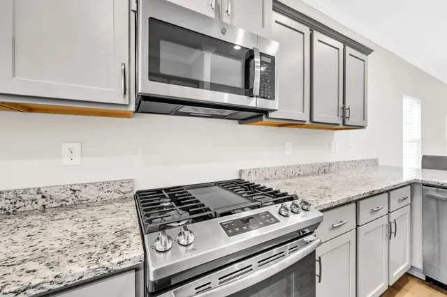 a stove top oven sitting inside of a kitchen
