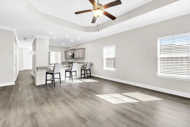 a view of a livingroom with furniture and a ceiling fan