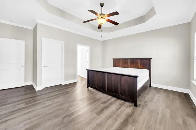 a view of an empty room with wooden floor