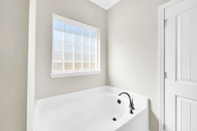 a white bath tub sitting next to a window