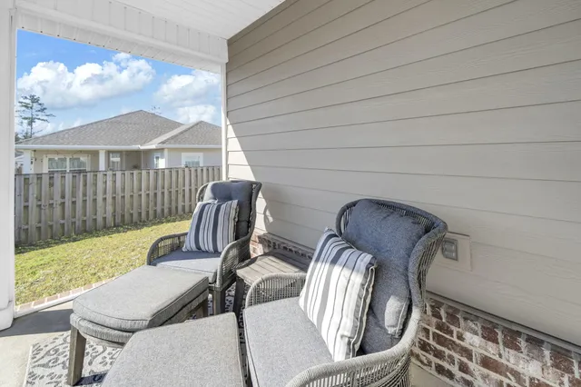 a view of a chair and table in the patio