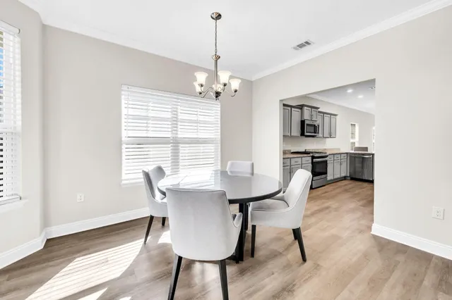 a view of a dining room with furniture window and wooden floor