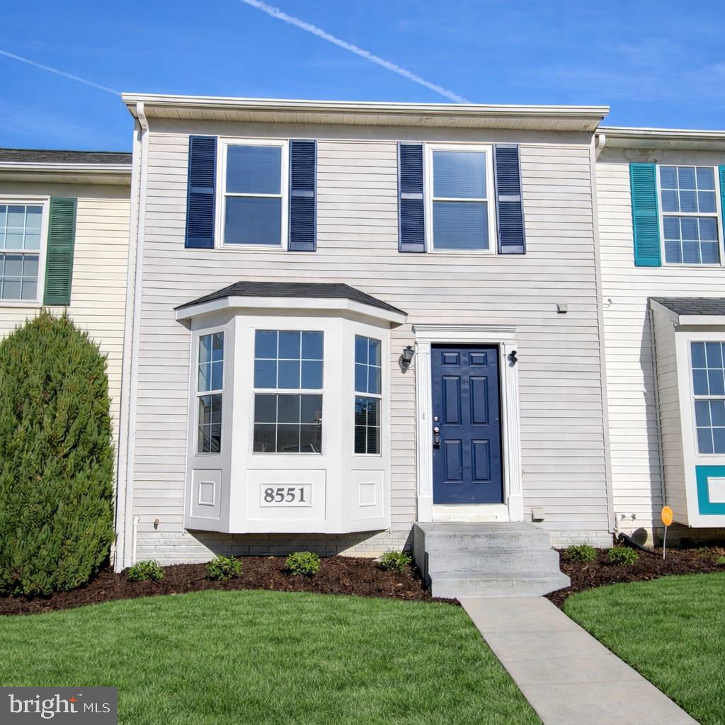 a front view of a house with a yard