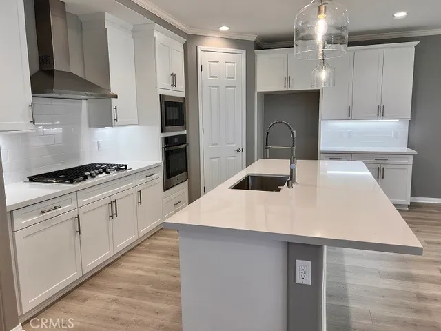 a kitchen with a sink a stove and refrigerator