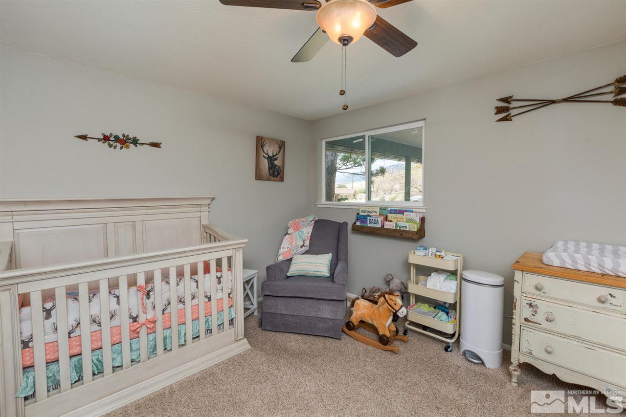 20875 Ames Lane Reno, NV 89521 - Photo 16 of 25 a living room with furniture and a chandelier