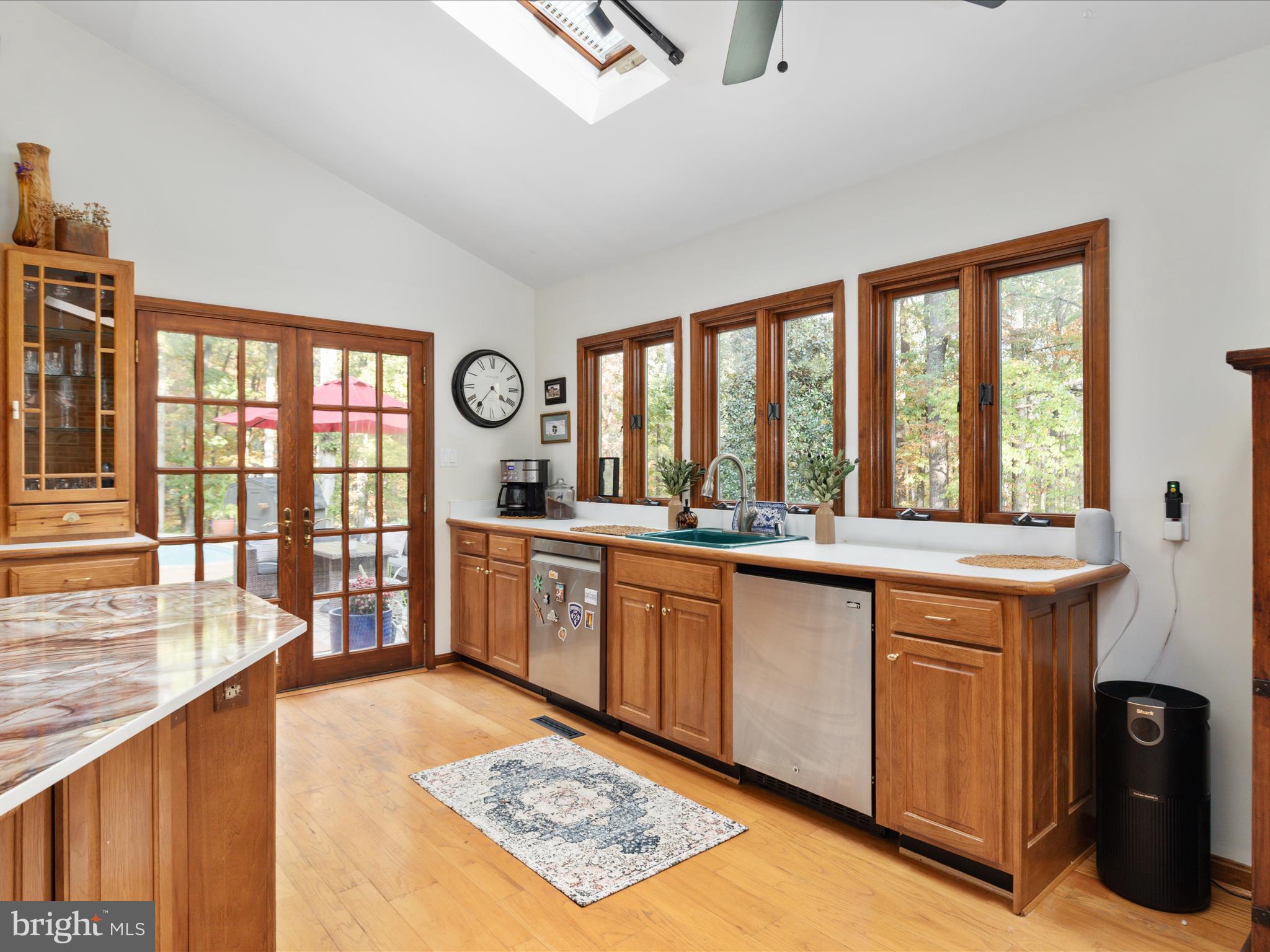 7261 Baldwin Ridge Road Warrenton, VA 20187 - Photo 15 of 76 a large kitchen with stainless steel appliances granite countertop a stove a sink and a granite counter tops with wooden floors