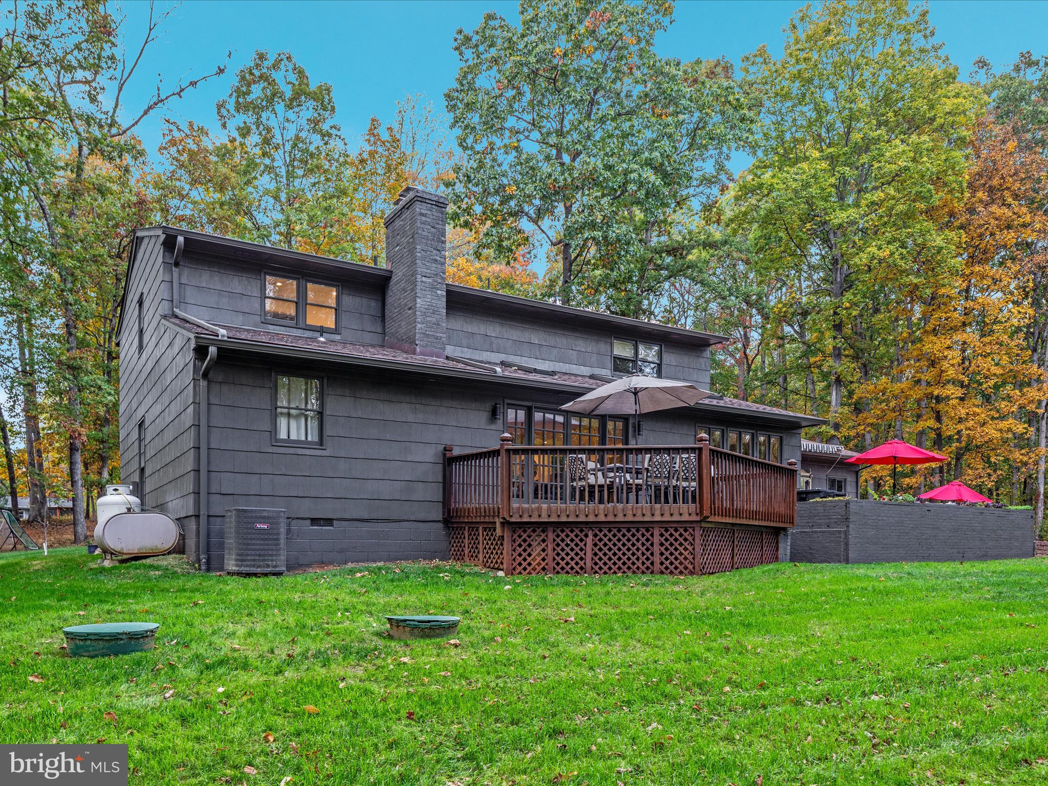 7261 Baldwin Ridge Road Warrenton, VA 20187 - Photo 48 of 76 a view of a wooden house with a big yard and large tree