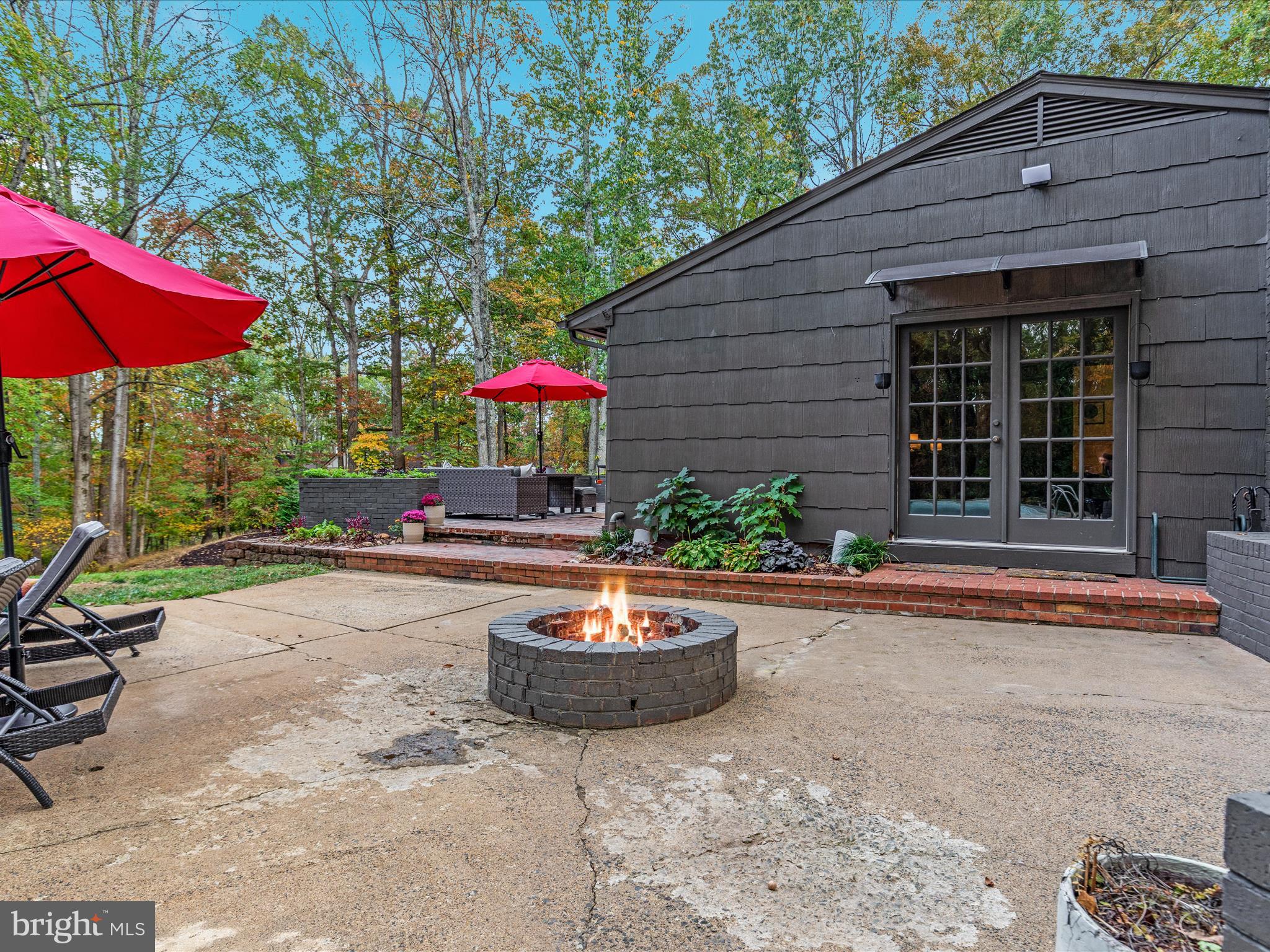 7261 Baldwin Ridge Road Warrenton, VA 20187 - Photo 55 of 76 a view of a backyard with table and chairs under an umbrella