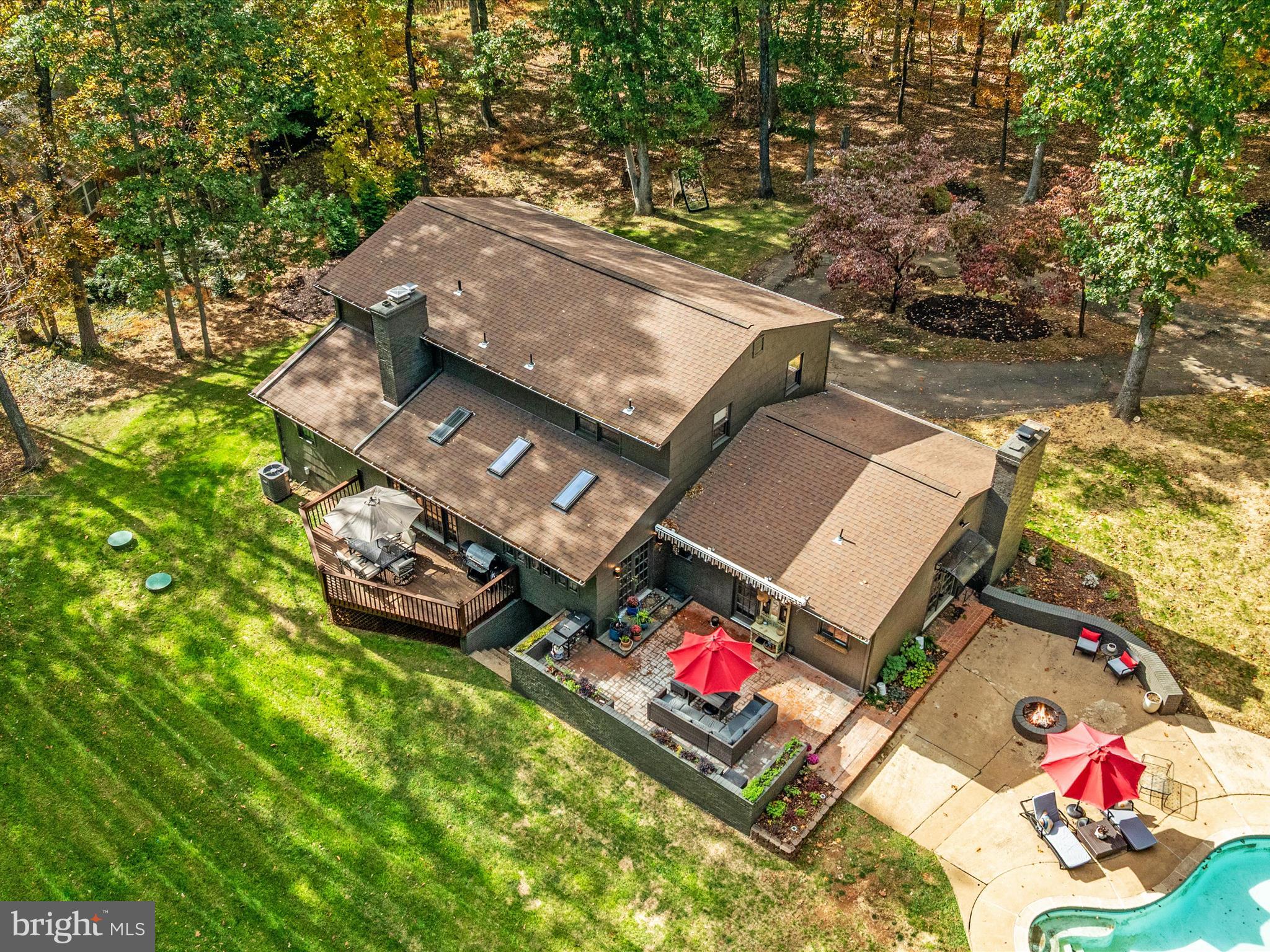 7261 Baldwin Ridge Road Warrenton, VA 20187 - Photo 70 of 76 an aerial view of a house with swimming pool and red chairs