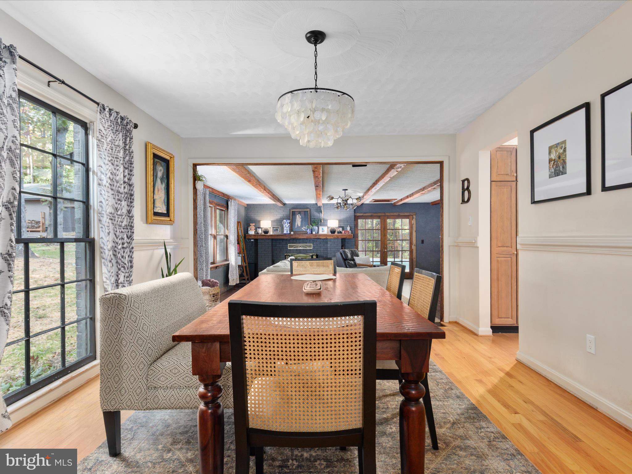 7261 Baldwin Ridge Road Warrenton, VA 20187 - Photo 7 of 76 a dining room with furniture a chandelier and wooden floor