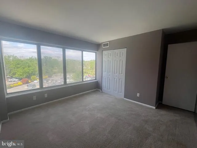 a view of a workspace with a window and couch