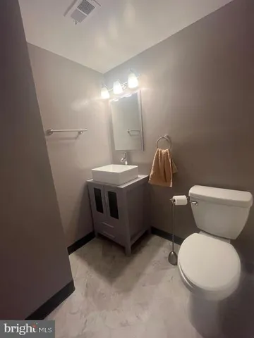 a white toilet sitting next to a bath tub and a shower