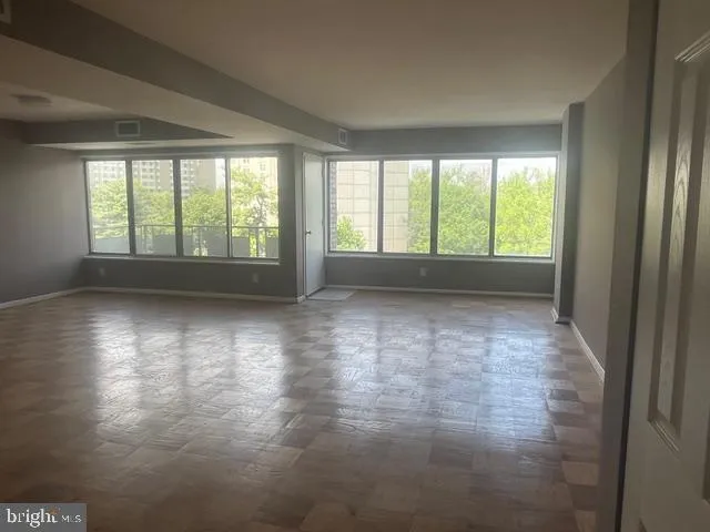 a view of room with window and hardwood floor