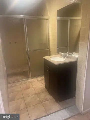 a living room with lots of furniture and a view of kitchen