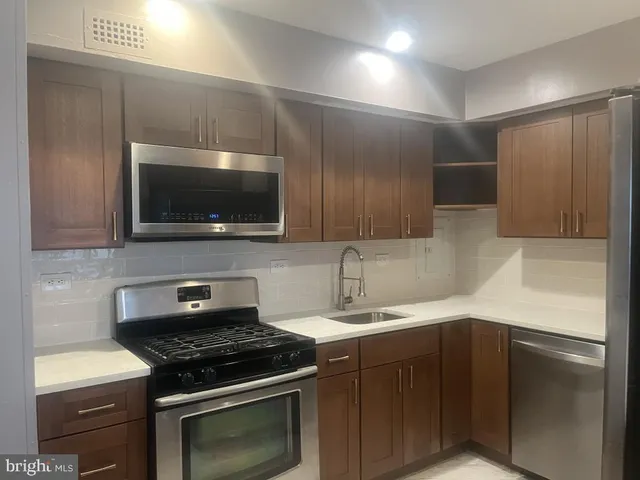 a kitchen with a stove and a microwave