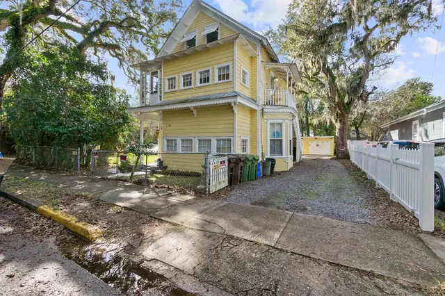 a backyard of a house with barbeque oven and outdoor seating