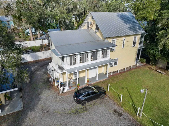 an aerial view of a house with a yard