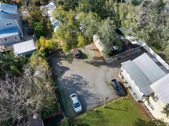 a kitchen with stainless steel appliances granite countertop a refrigerator a stove a sink dishwasher and white cabinets with wooden floor