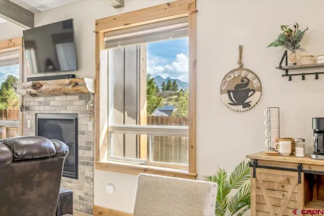 a living room with furniture and a floor to ceiling window